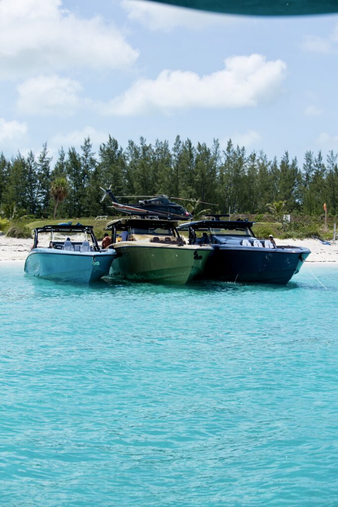 3 Midnight Express Yachts rafted up in front of helicopter